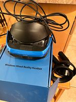 Headset on top of box with cable and one controller partly visible