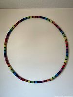 Full view of full‐circle multicolour hula hoop on wall
