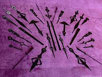 All clock hands laid out radially on purple background