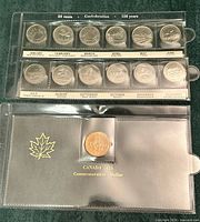 Full view of both plastic sleeves showing 12 provincial/territorial quarters and commemorative dollar