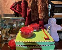 overall lot with storage box, garland rolls, tree skirt, puzzle and gingerbread figure visible