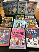 All 12 cases arranged on table showing front artwork