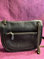 Rear view of Coach pebbled leather bag showing exterior zip pocket and chain strap