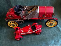 Both diecast cars side by side showing scale, colours, wheels, interiors