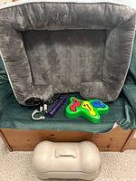 Overview of all items: bed, harness, chew stick, puzzle feeder, food container