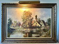 full view of framed painting with attached picture light illuminated