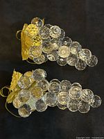 Both lucite grape clusters shown on dark background