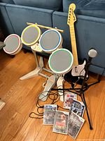 Full bundle—drums, guitar, mic on stand, five Wii games visible