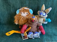 Group shot of all three Olympic mascot plush toys