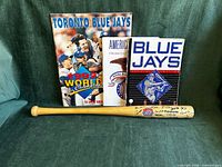 Lot overview showing bat and three visible publications