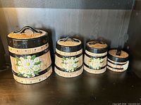 All four ceramic barrel-style canisters lined up