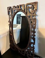 Full view of oval mirror showing frame and glass