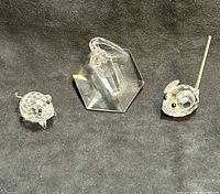 Three crystal pieces grouped on dark background