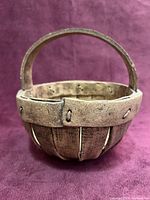 Full view of bowl showing basket form and handle