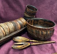 Group view of large bowl, six small bowls stacked, tray, fork and spoon