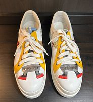 Top view of both sneakers showing robot appliqués, laces, yellow panels