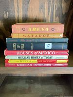 Stack of eight hardcover Mexico-related books, spines visible