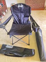 Front view of one Coleman folding chair with carry bags shown