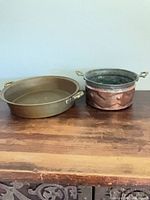 Pan and pot side by side on table