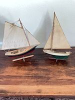Both sailboat models side by side on table