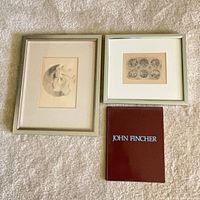Overall view of two framed drawings and book