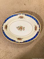 Front of J&G Meakin oval platter showing floral centre and cobalt rim