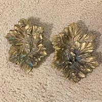 Front view of both brass leaf dishes showing detailed veined design