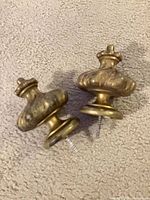 pair of brass curtain pulls front view