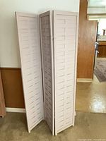 Full view of screen partially unfolded showing three slatted panels