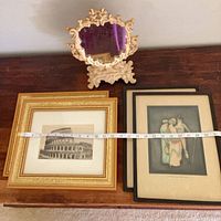 Vanity mirror and two framed prints with measuring tape for scale