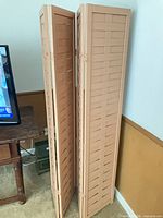 Full view of folded wooden screen showing all panels