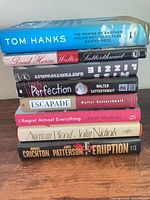 Stack of eight books showing spines for all titles