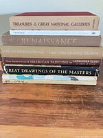 Stacked side view showing all eight book spines and titles