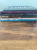 Side view of stacked books showing spines