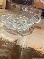 Top view of cut glass nappy dish showing starburst pattern and handle