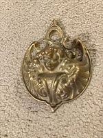 Front view showing ornate cherub and scroll design