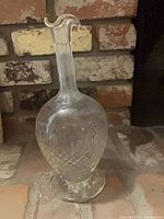 Full view of decanter front showing ruffled rim and etched body
