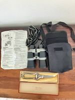 Binoculars with case, instruction sheet and boxed shears displayed