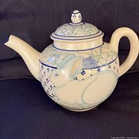 Full view left side showing rabbit design and spout