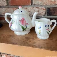 Teapot and creamer side by side showing size relationship and pattern