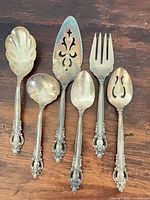 Front view of all six silver-plated serving utensils