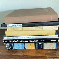 Stack of books showing spines: Braque, unidentified cream spine, The World of Marc Chagall and wide-format volumes