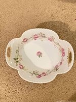 Top view of quatrefoil porcelain serving dish showing floral pattern and gold accents