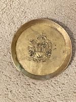 Full view of brass plate front showing coat of arms