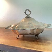 Side view showing covered dish on feet