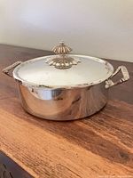 Dish with lid on showing handles and finial