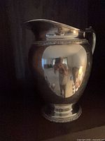 Full view of silver plate pitcher standing