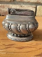 Front view showing full lighter and decorative crown-like base