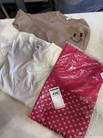 Overview of all three clothing items: scarf, sweatshirt, T-shirt