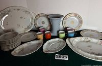 Full lot with platters, saucers, mugs, plates, vase visible